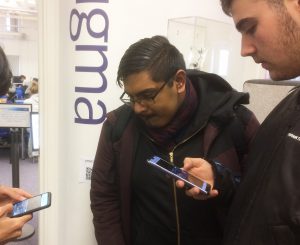 Students play BEACONING on smart phones in Library building